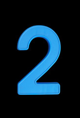 Plastic number isolated on black background, number 2