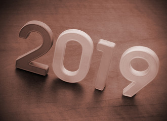 Numbers 2019 on wooden table close up as symbol of 2019 year