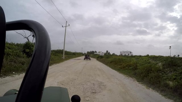 Dune buggy driving on dirt road on the outskirts of Costa Maya, Mexico during the day 11