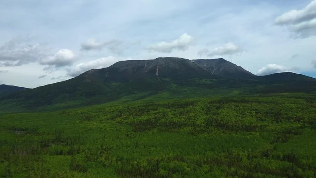 Slowly flying over Baxter State Park away from Mount Katahdin Late Spring AERIAL