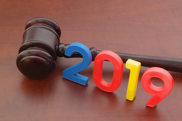 Wooden judge gavel and numbers 2019. Concept of new laws in 2019 and changes in legal system.