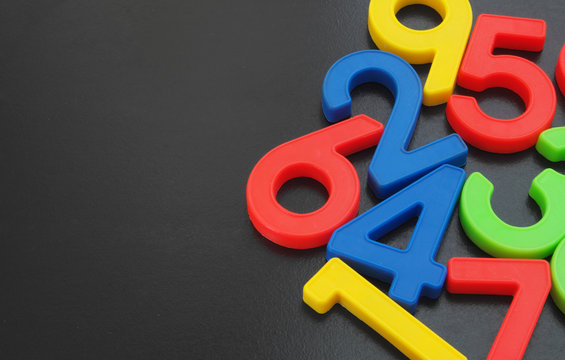 Colorful numbers on black table  with room for text