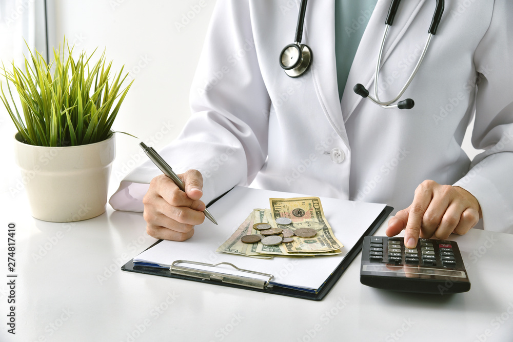 Wall mural Medical fee, Health insurance, Doctor writing medication note and calculate the examination charges in hospital, Money saving for healthcare services.