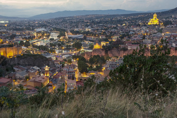 Panoramic view of the city of Tbilisi. Georgia with night lights at sunset from a hill