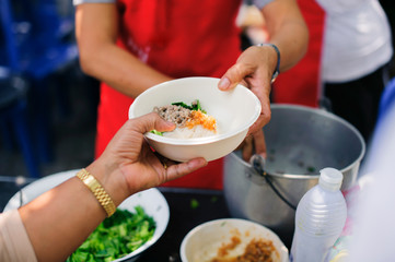 Participation in sharing food for the poor : The Concept of Love : The beggar is waiting for food from charity aid : Charity food shared to everyone in society and the poor need this charity food