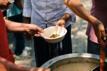 Participation in sharing food for the poor : The Concept of Love : The beggar is waiting for food from charity aid : Charity food shared to everyone in society and the poor need this charity food