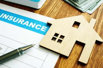 House insurance form for homeowners and model of home.