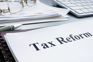 Tax reform act and stack of papers.