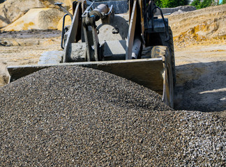  tractor collects scoop with  gravel. excavator extracts sand and gravel for  concrete mix.