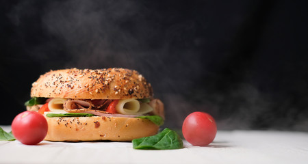 Delicious classic blt sandwiches with ham, cheese, bacon, tomatoes. Breakfast and fast food meal. on isolated black background wooden and text copy space.