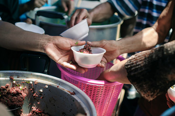 Poor people receiving food from donations : Homeless people are helped with food relief, famine...