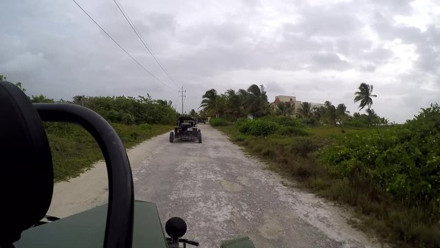 Dune buggy driving on dirt road on the outskirts of Costa Maya, Mexico during the day 12