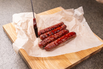 Food and delicious concept - Horse meat sausage covered with ketchup