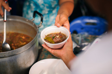 The concept of the beggar problem on earth : The Hand of the Beggars receives charity food from...