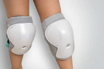 Pair of knee pads wearing on legs of child © andriano_cz