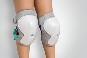 Pair of knee pads wearing on legs of child