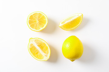 Flat lay composition with lemons on white background, space for text