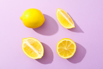 Flat lay composition with lemons on color background, space for text