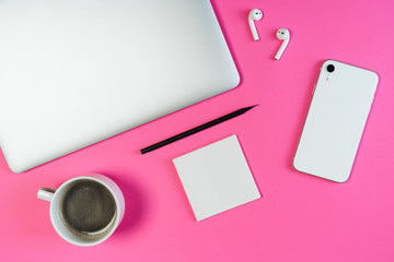 Laptop Phone Coffee Sticker Workplace Top View. White Smartphone, Airpod, Hot Morning Drink and Pencil on Minimal Clear Contemporary Pink Desk Background. Freelance Workspace Inspiration Concept