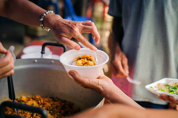 The Concept of Hunger : Food needs of the poor in society Help with Food Donation : Homeless people pick up charity food from the food donors in society : The concept of the beggar problem on earth