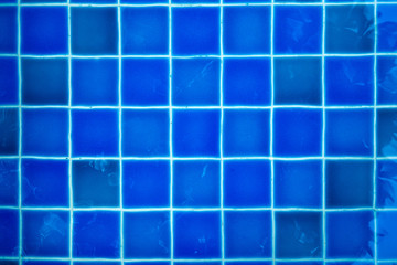 texture of Blue tiles of the swimming pool under clean water background