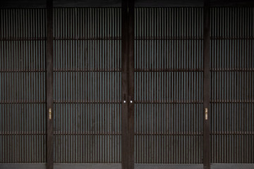 wooden wall of window and old house in Japan. low key and soft focus.