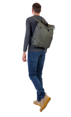 Naklejka premium back view of walking man with green bag.