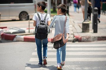 Little brother boys cross the road on the crosswalk - Powered by Adobe