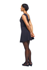 Side view of black woman in a brown dress.