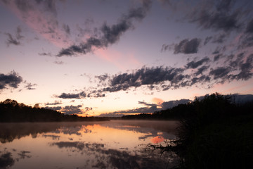 Sunset on the river after rain with expressive clouds. nature of Russia