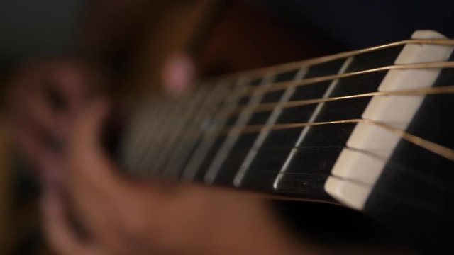 Close up vibrating string acoustic guitar
