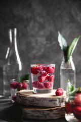 Strawberries in water on a dark gray background. Healthy food, fruit. A bouquet of flowers