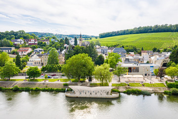 Fototapeta premium Aerial view of Schengen town center over River Moselle, Luxembourg, the place where Schengen Agreement signed, the birthplace of a Europe without borders. Tripoint of borders with Germany and France