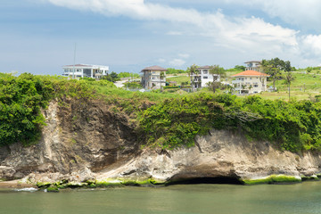 Fototapeta premium Picturesque view of houses on a green cliff