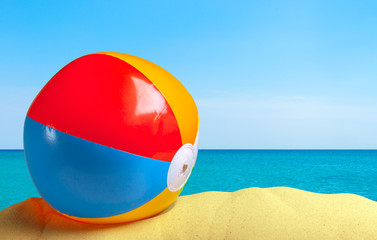 Fototapeta na wymiar Beach ball on a white sandy background