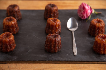 French pastry Caneles de bordeaux rum and vanilla flavor thick caramelized crust on black slate...