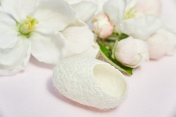 Fototapeta na wymiar silkworm cocoon close-up for beauty treatments and flowers.