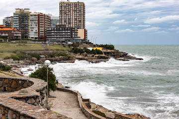 Panoramic of buildings facing the sea in Mar del Plata (Argentina) with wave breakers