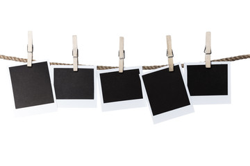 Blank pieces of paper and clothespins isolated on white