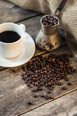 coffee beans and turk on a wooden background