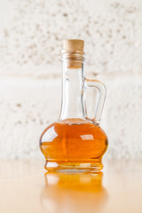 Obraz na płótnie Canvas Cruet of Apple Cider Vinegar on a table