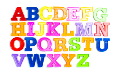 Heap of plastic colored alphabet letters close up.