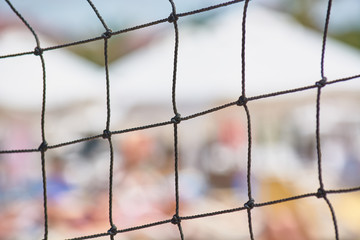 Square beach volleyball net for playing on beach.