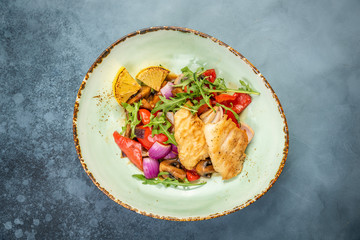 Pieces of fried fish with vegetables. Top view