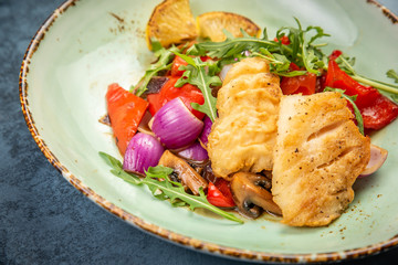 Pieces of fried fish with vegetables. Top view