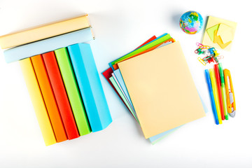 Back to school. Textbooks Mock up for different school sciences, butt facing up. Bright, multi-colored stationery, textbooks and notebooks on a white background for school. Isolated, Flat Lay, Copy sp