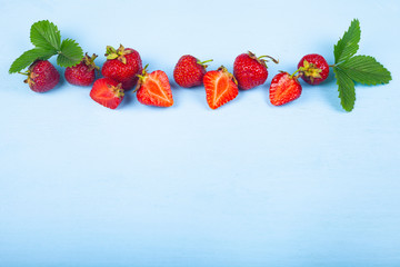 Ripe strawberries on a blue table.