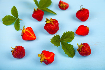 Ripe strawberries on a blue table.