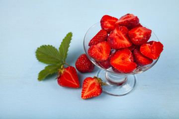 Ripe strawberries on a blue table.