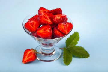 Ripe strawberries on a blue table.